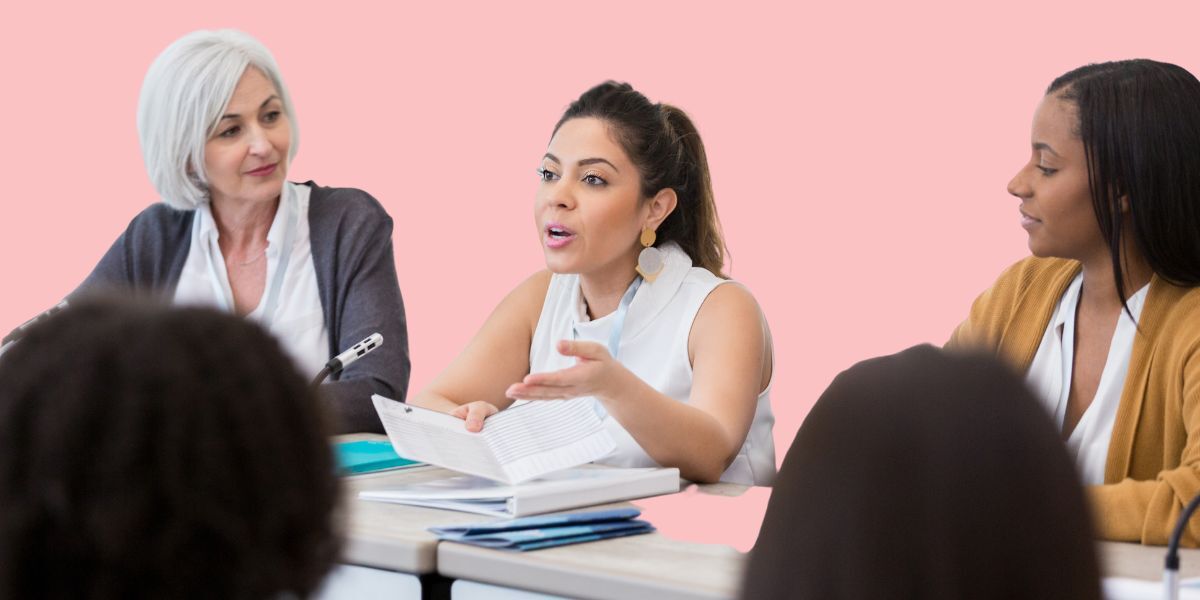 three women talking to each other